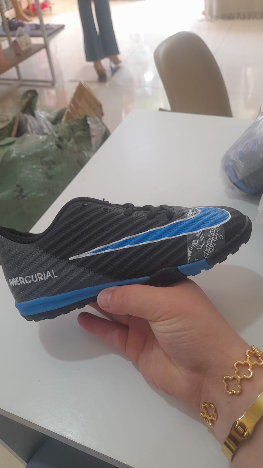 Nike Mercurial kids black turf football shoes with blue swoosh and carbon texture
