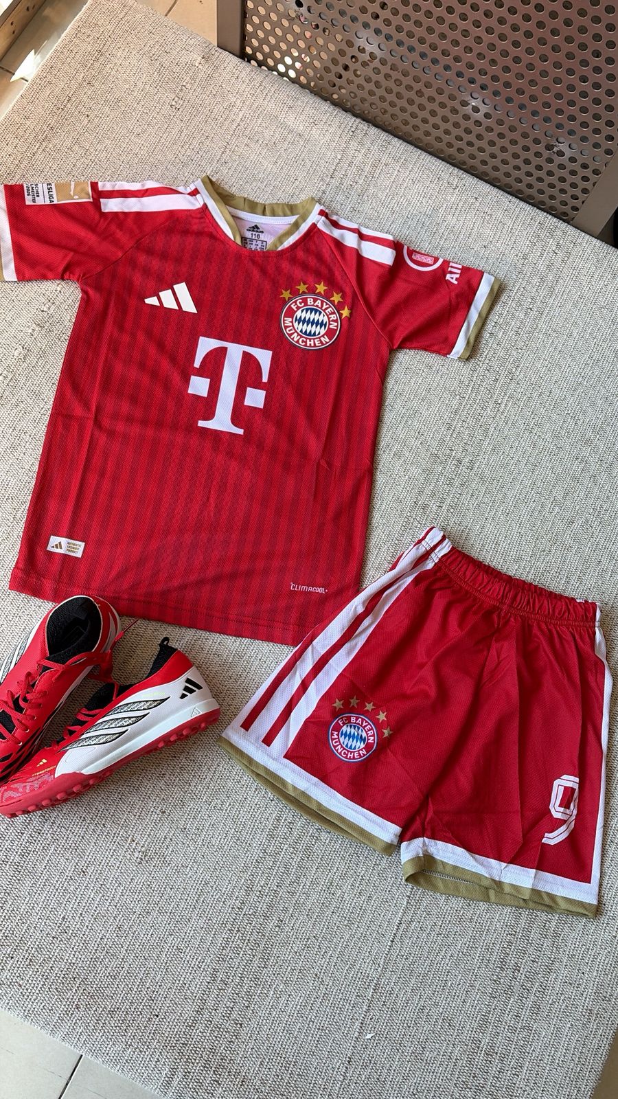 FC Bayern München kids red Adidas football kit number 9 jersey and shorts flat lay