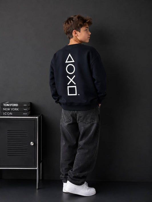 Boy wearing navy PlayStation symbols graphic sweatshirt