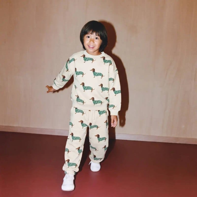Child wearing cream all-over dachshund print sweatshirt and joggers set