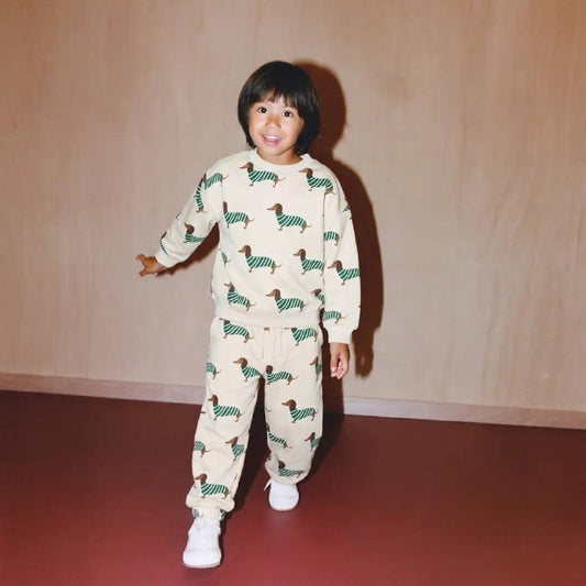 Child wearing cream all-over dachshund print sweatshirt and joggers set