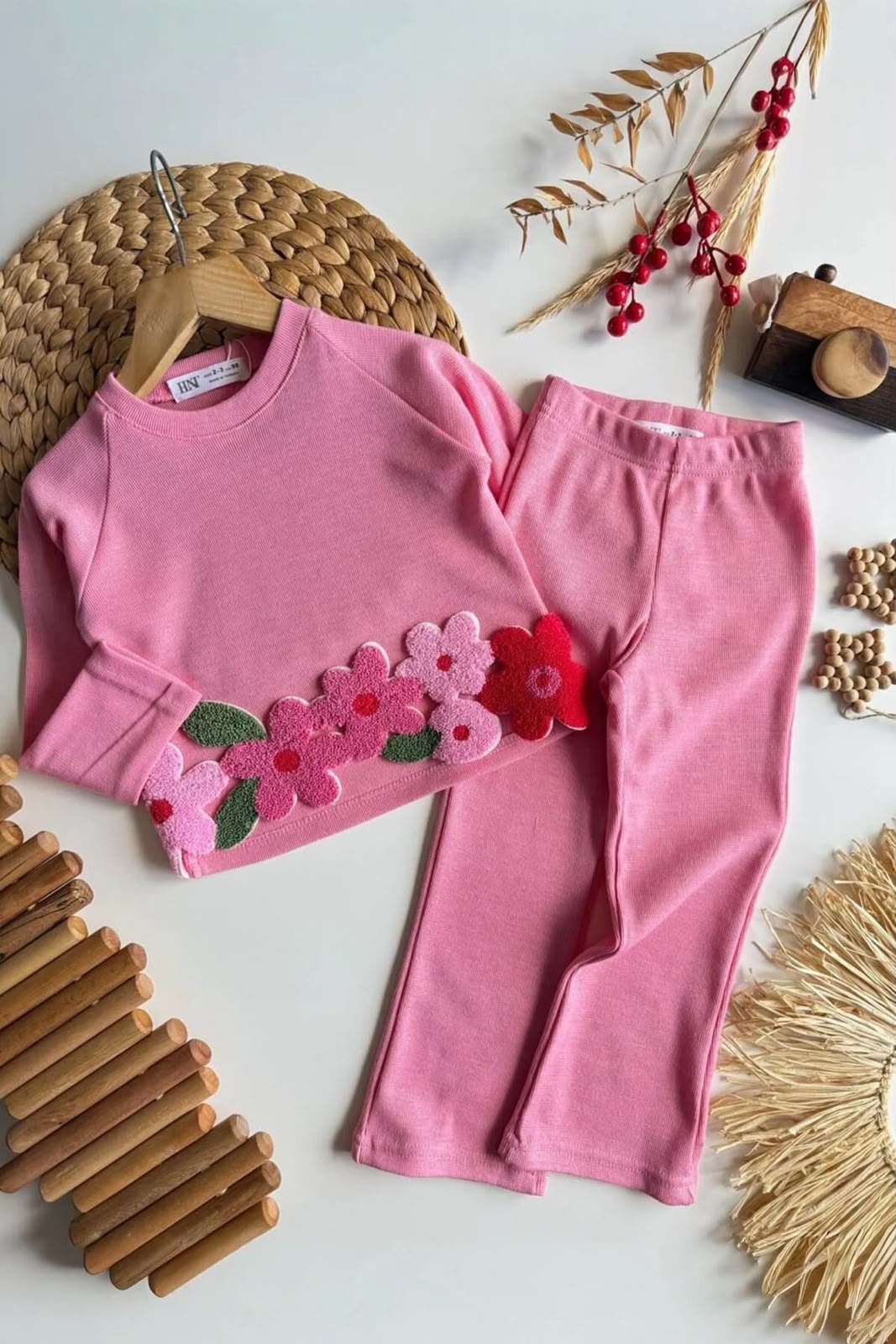 Original photo of pink long-sleeve top with textured flower appliqués and matching pink pants