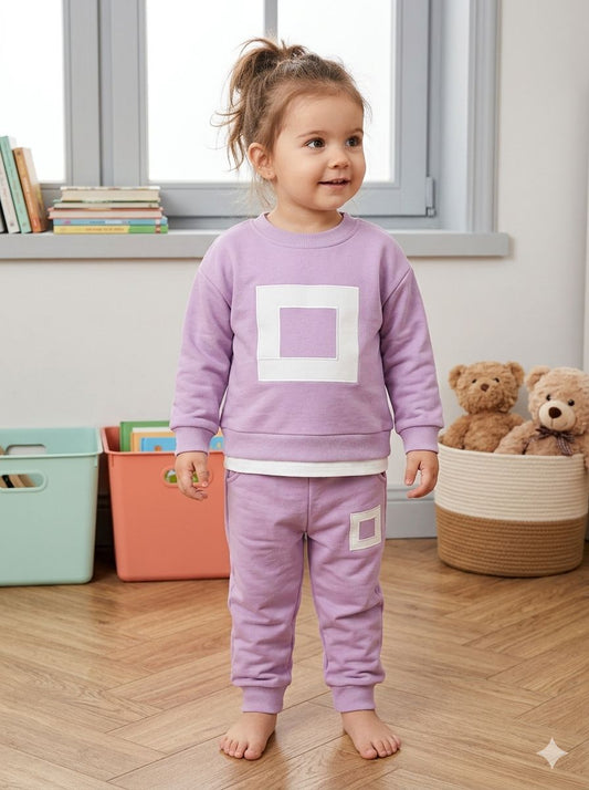 Child wearing a lilac sweatshirt and jogger set with white square details