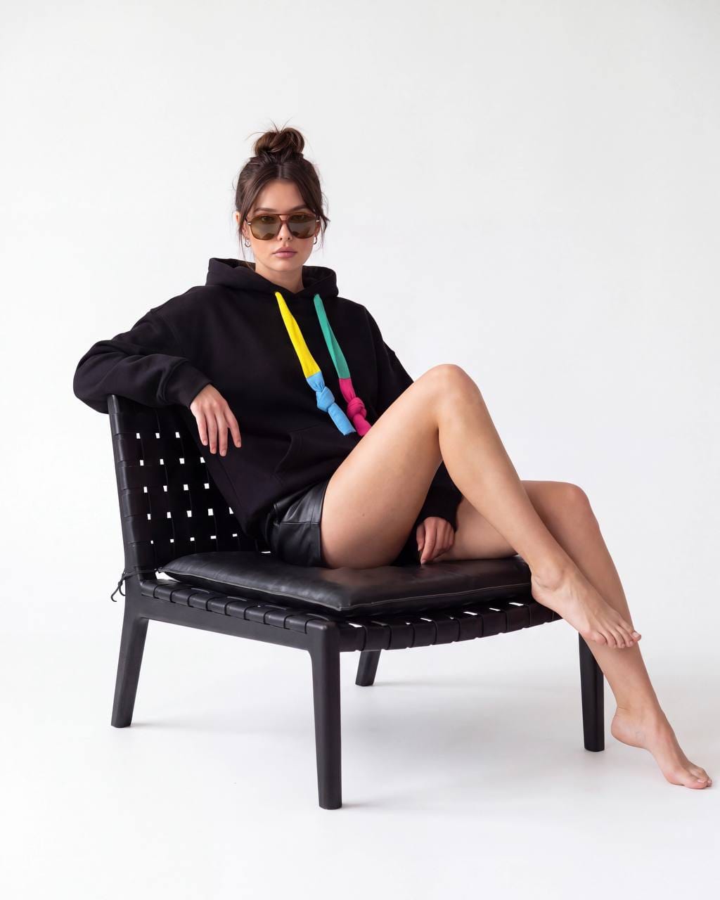 Woman wearing a black hoodie with multicolored drawstrings
