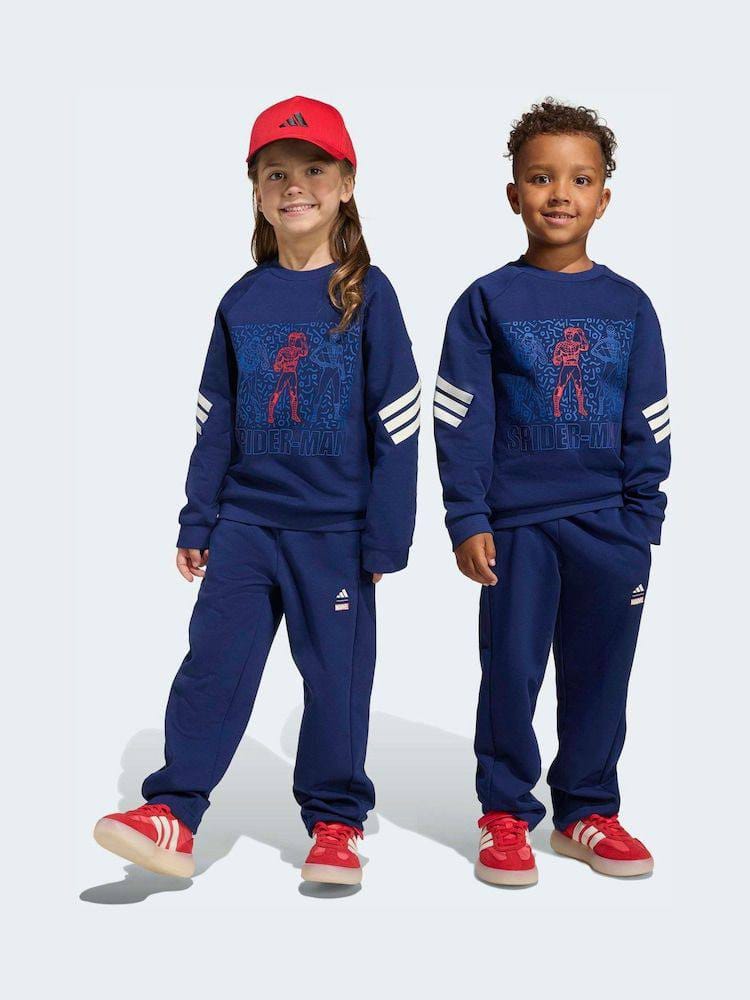Kids wearing navy graphic sweatshirt and jogger sets with white sleeve stripes