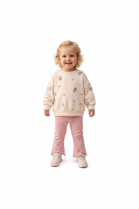 Baby girls cream sweatshirt and pink flare pants set on white background