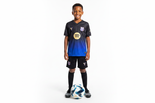 Boy wearing FC Barcelona x Kobe special edition kids football kit black blue gradient jersey and black shorts