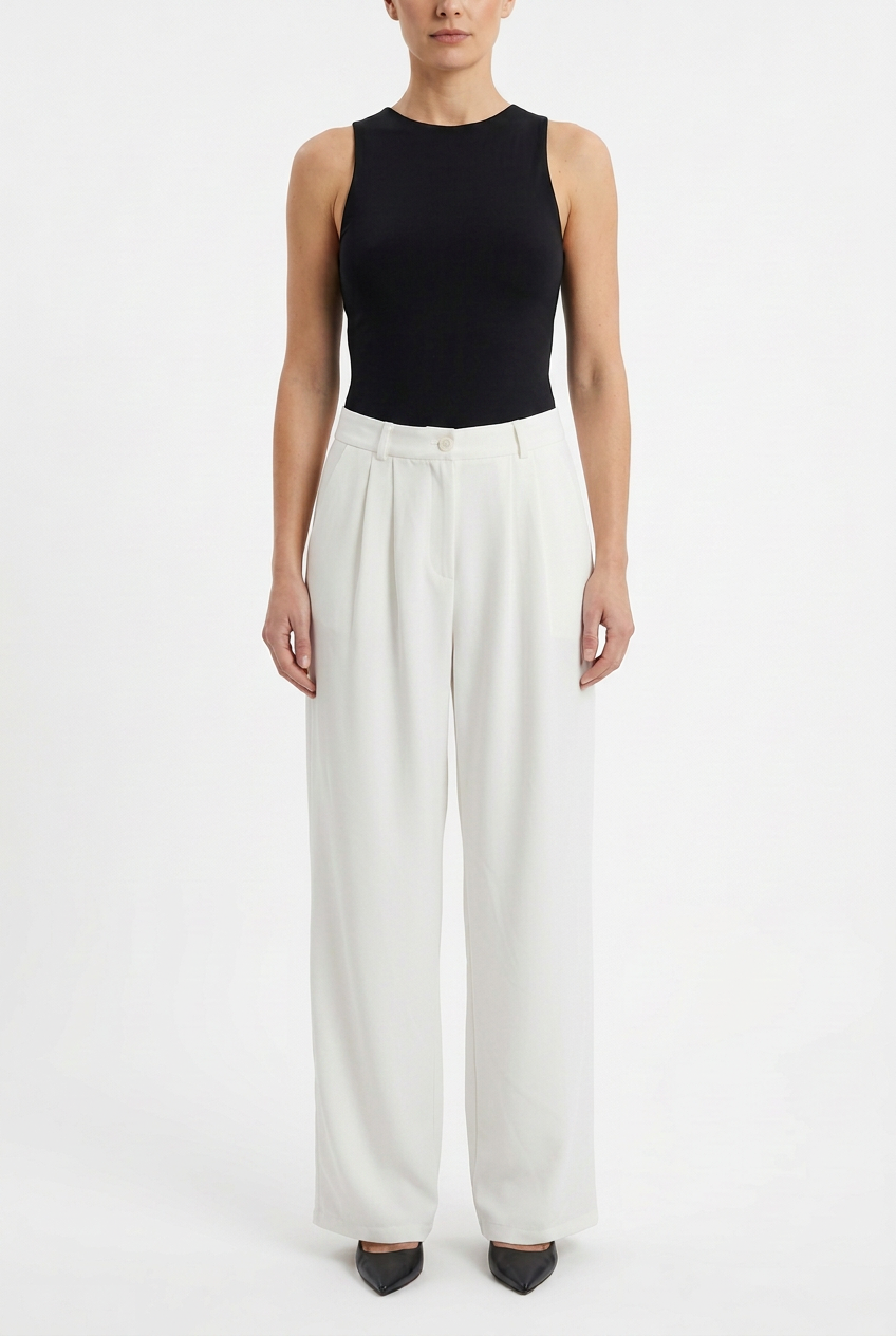 Model wearing long white mid-rise wide-leg trousers with a black top