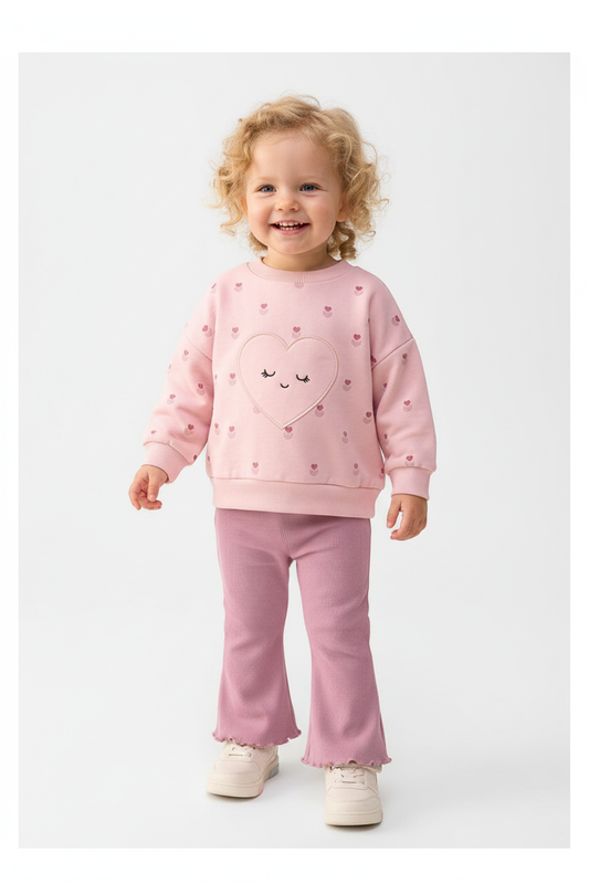Baby girls pink heart sweatshirt and mauve flare pants set on white background