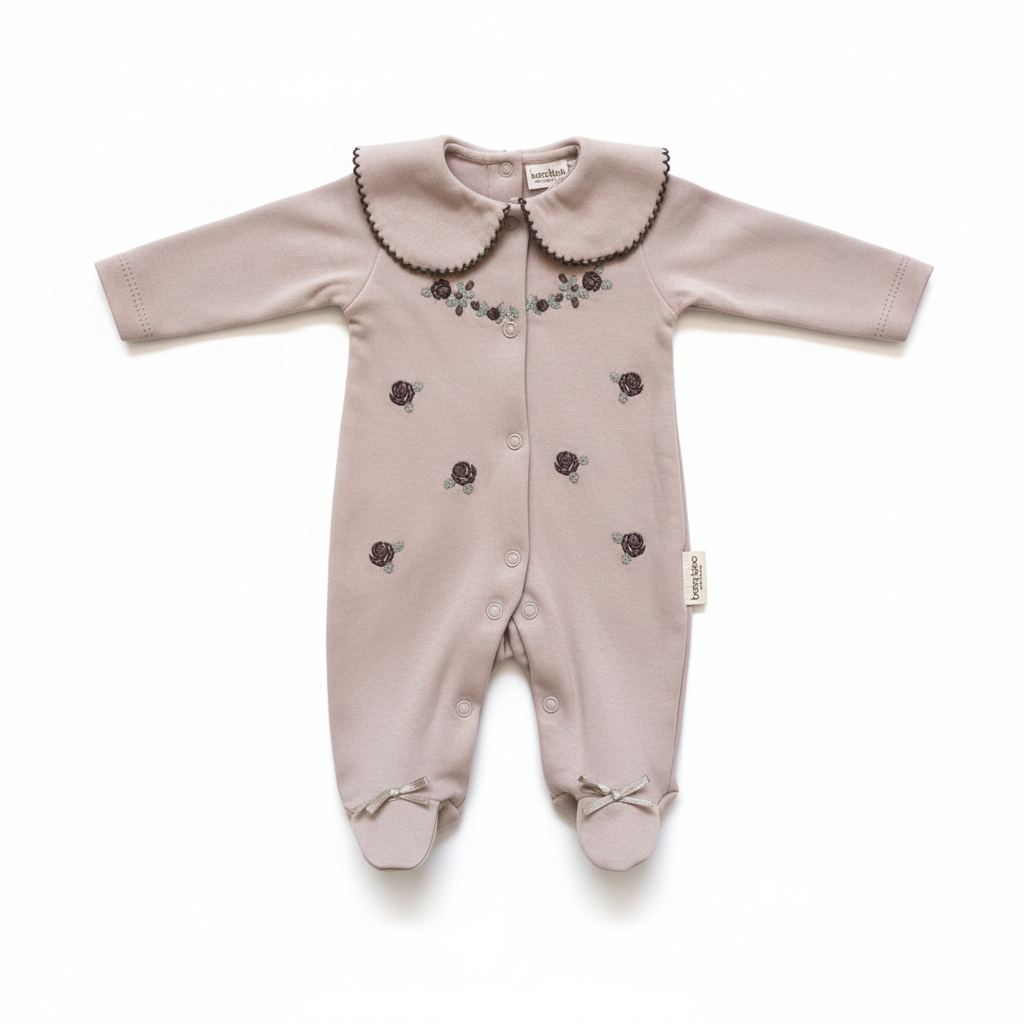 Dusty pink baby sleepsuit with peter pan collar and floral embroidery on white background