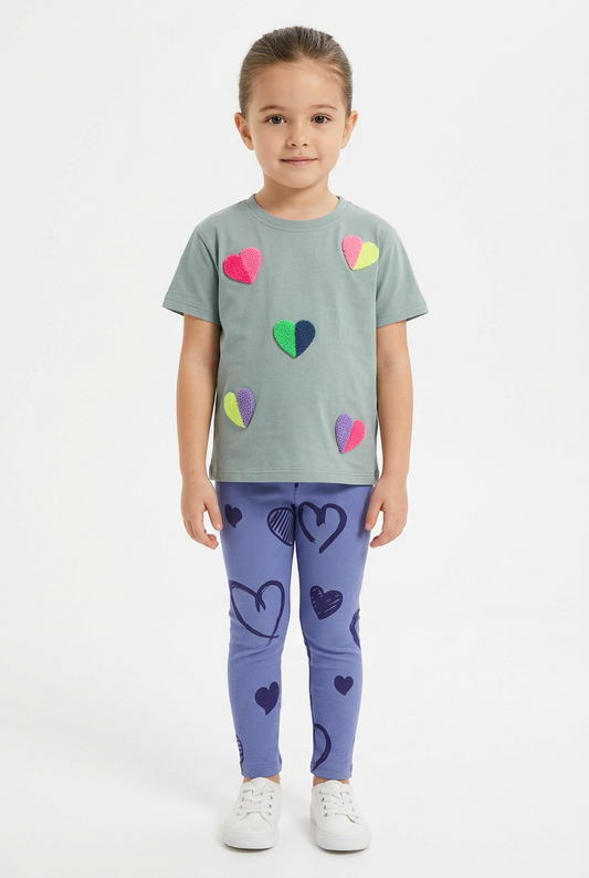 Girl wearing sage-green colorful heart top and blue-purple heart-print leggings